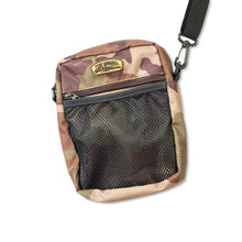 Load image into Gallery viewer, Tide Apparel Angler Sling Bag in camo print, featuring a mesh front pocket and adjustable strap for convenience.